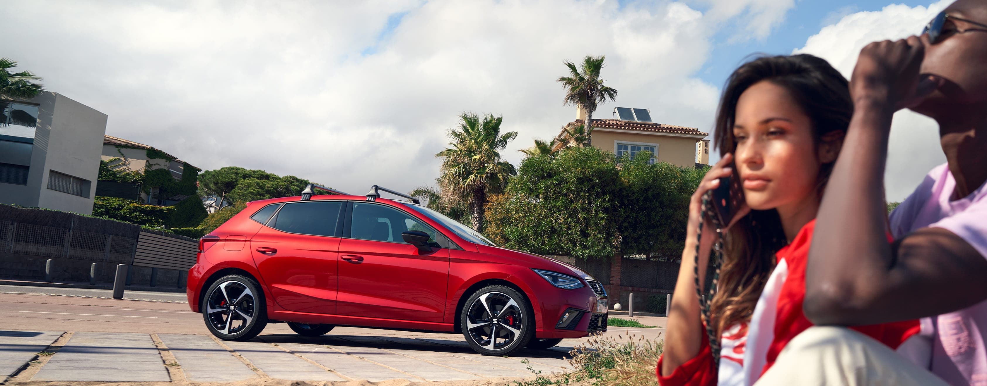 SEAT Ibiza desire red colour parked while a couple is calling for assistance