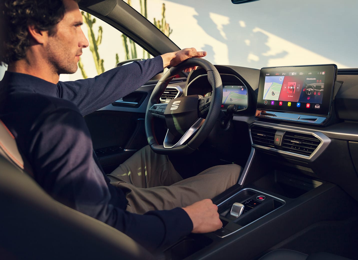 SEAT Leon driver in cockpit charging phone