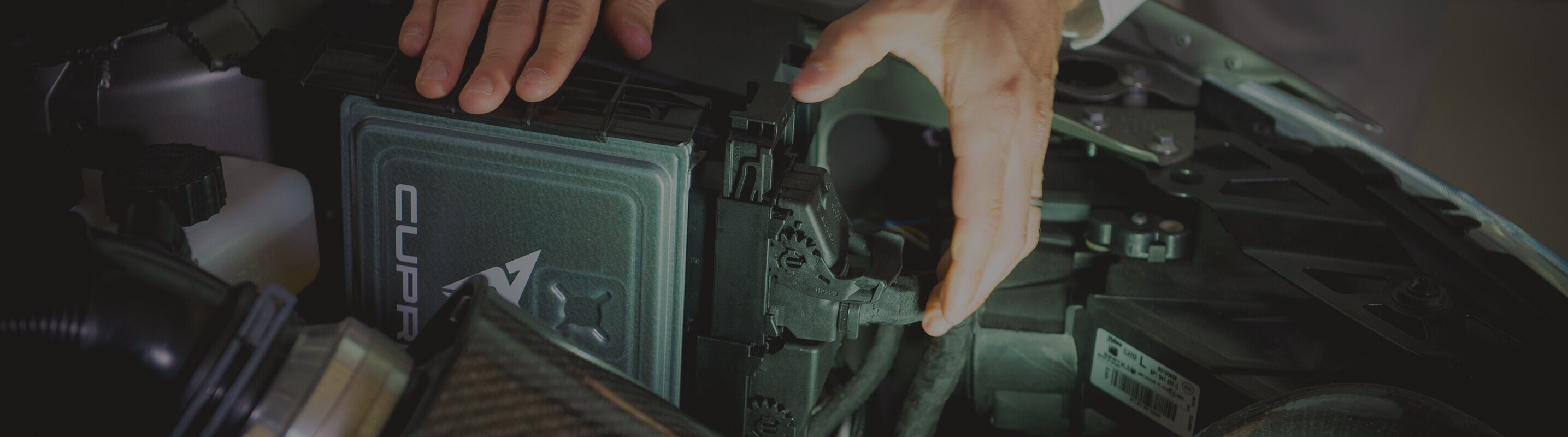 Foreground of a CUPRA motor - The digital brain of a champion