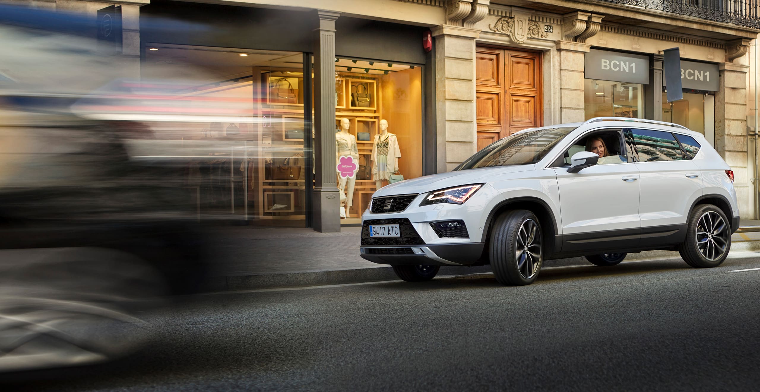 SEAT new car services and maintenance – white SEAT Ateca SUV driving in the city