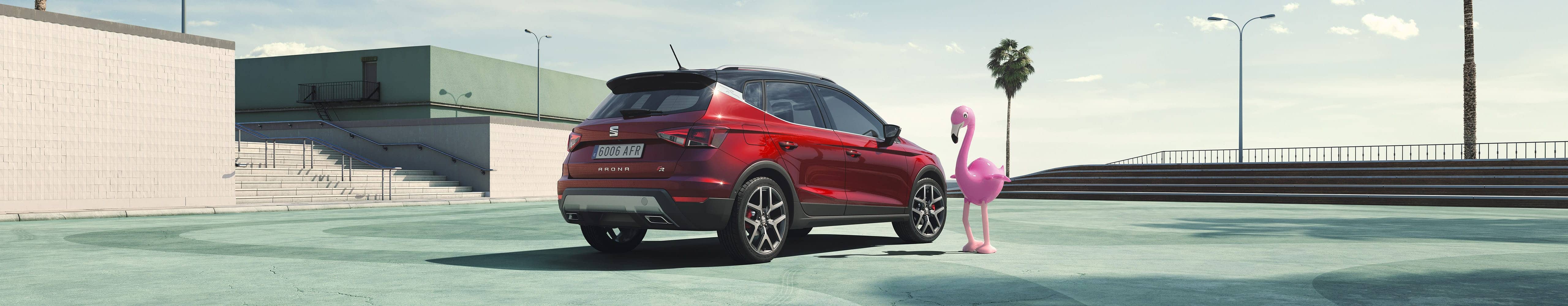 desire red SEAT Arona outdoor side angle view