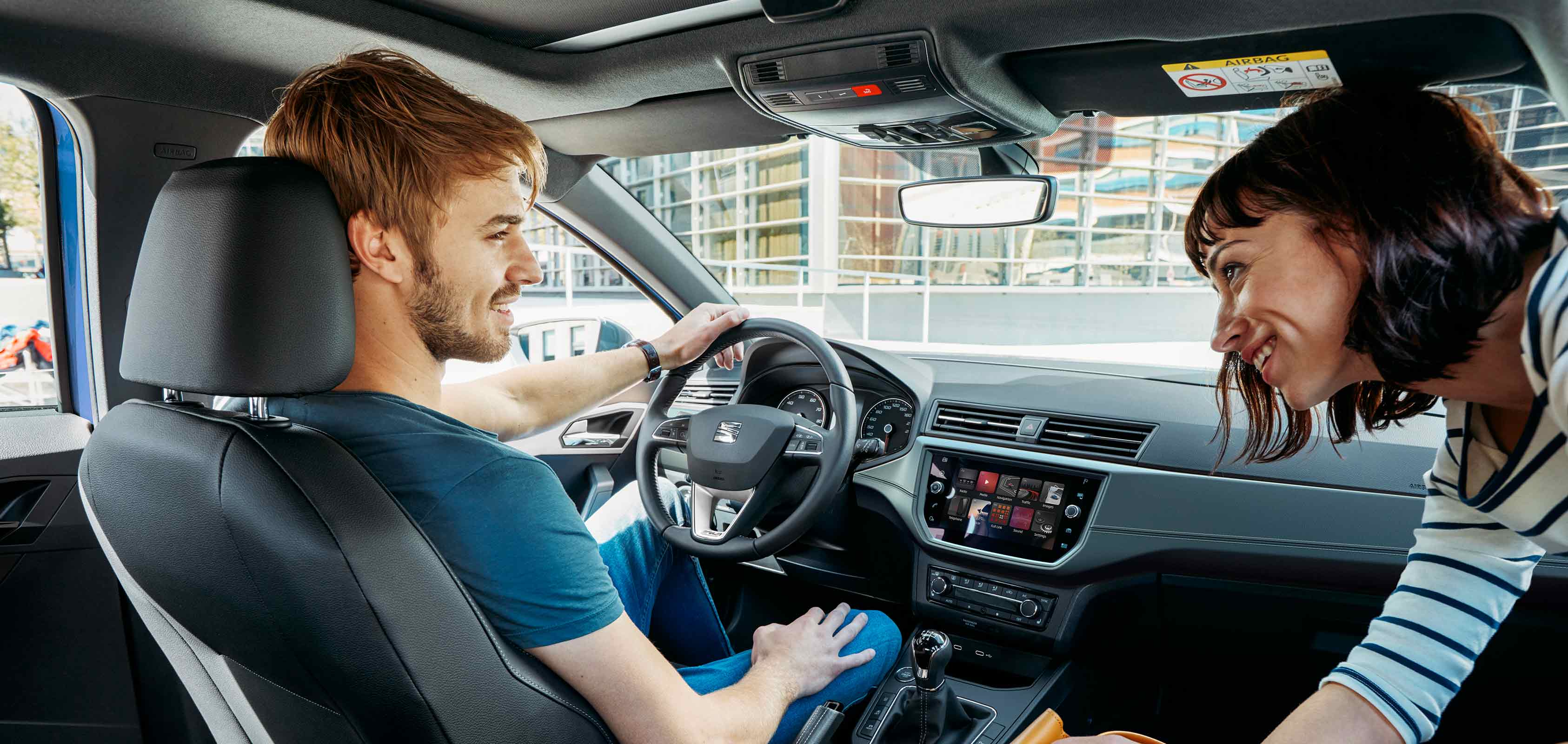 SEAT Ibiza Xcellence 2018 detailed interior technology. Interior front car image with men and woman