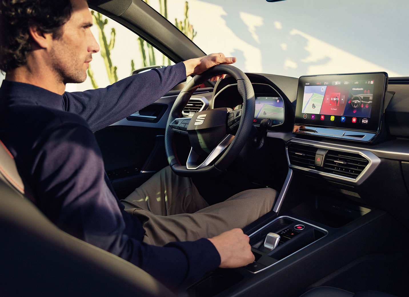 SEAT new car services and maintenance – interior view of a man driving a SEAT new car